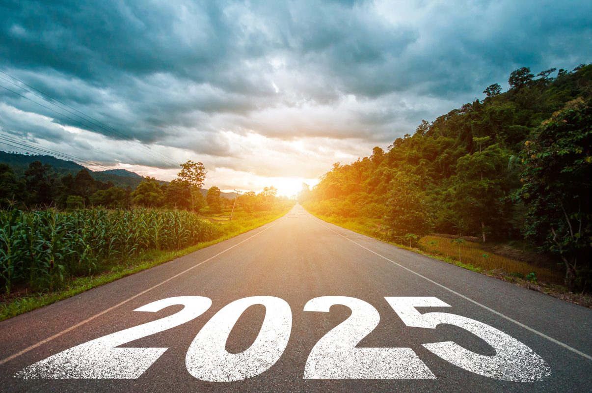 New year 2025 or straight forward concept. Text 2025 written on the road in the middle of asphalt road with morning sunlight. Concept of planning, goal, challenge, new year resolution.